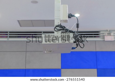 A white overhead projector on ceiling indoors