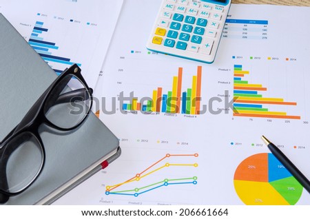 Financial papers, book and office supplies closeup