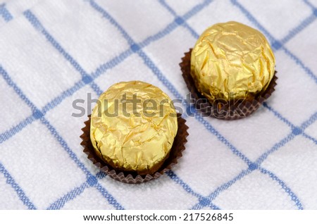 Chocolates wrapped in golden on Fabric Rips
