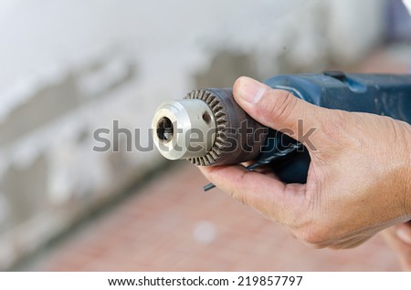 Man using drill. Close-up side view of man using drill