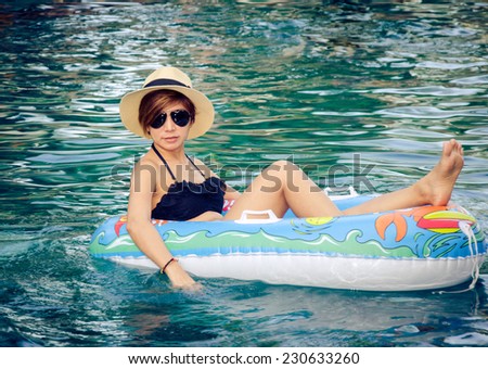 Woman sitting in  Swim Ring. Vintage image