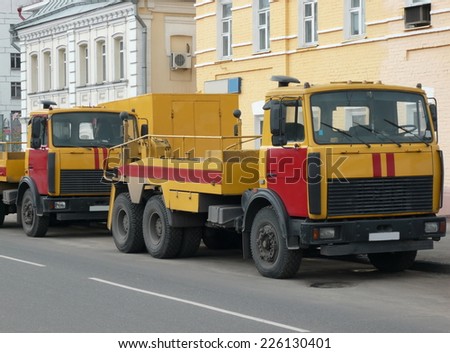 red-yellow emergency truck on asphalt road