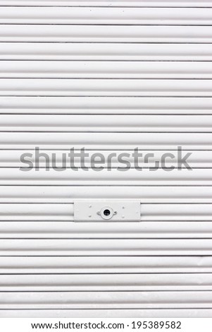 background of metallic roller shutter with door lock