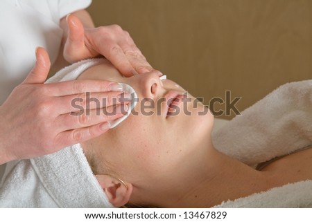 Closeup of human hands massaging a young pretty woman\'s face