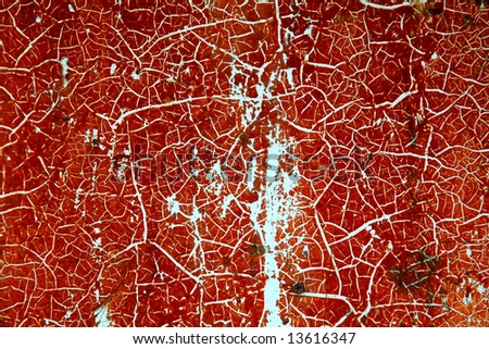 Abstract red background. A boat hull with red paint and white cracked lines.
