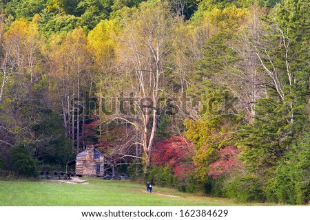 Fall foliage and an old cabin on display on Cade\'s Cove Loop Road  in  Great Smoky Mountains National Park, TN