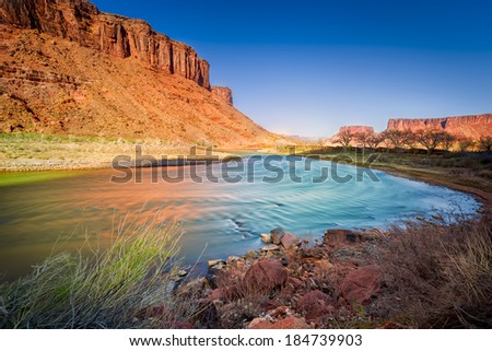 Late afternoon long exposure view of a colorful bend in the colorado River outside Moab, UT