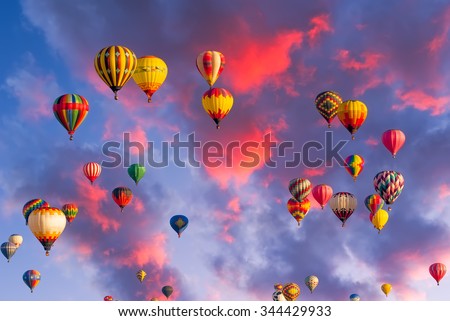 Colorful hot air balloons in flight  illuminated by early morning light