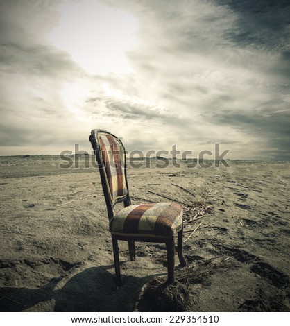 Wooden chair alone on Sand