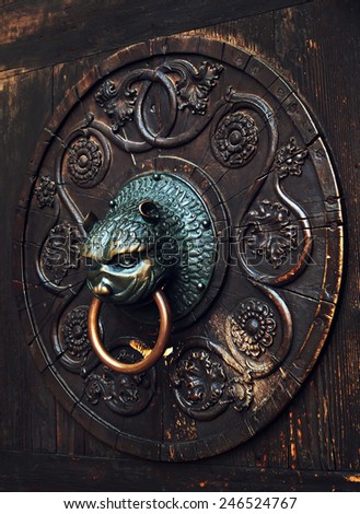 Antique knocker on a wooden door on facade of Cathedral of St. Maria (Dom Unserer Lieben Frau) in Augsburg, Germany