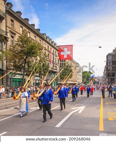 Zurich, Switzerland - 1 August, 2014: the traditional Swiss National Day parade passes the Bahnhofstrasse street. The Swiss National Day is the national holiday of Switzerland, set on 1 August.