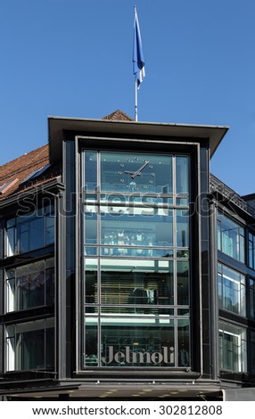 Zurich, Switzerland - 3 August, 2015: part of the facade of the Jelmoli building, above its main entrance, decorated with the flag of Zurich. Jelmoli is a department store in Zurich.