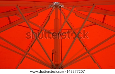 hot summer days under a large and stable red parasol to shade and recreation