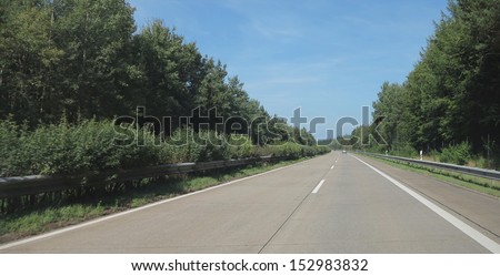 two-lane highway straight and green trees