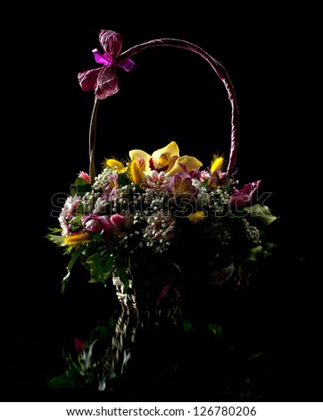 Flower arrangement and its reflection on a dark background