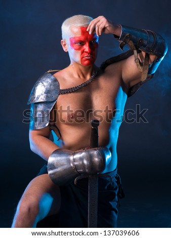 Knight with a sword on a blue smoky  background