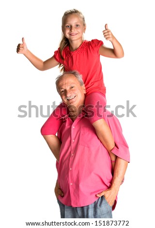 Portrait of a little girl enjoying piggyback ride with her grandfather on a white background