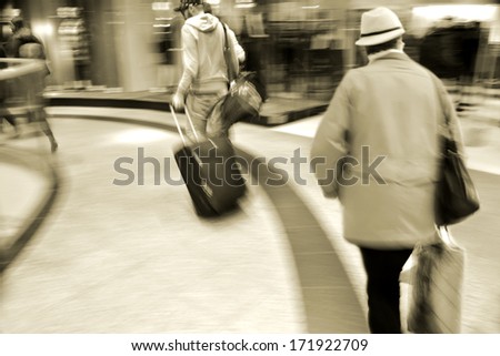 People silhouettes in shopping mall in motion blur