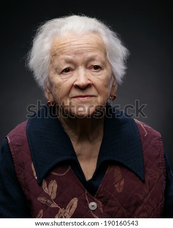 Portrait of old woman on a gray background
