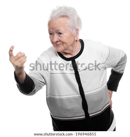 Portrait of a happy old woman pointing upwards on a white background