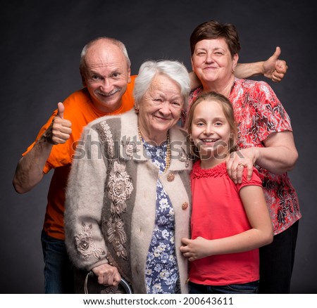 Happy multi-generation family on a gray background