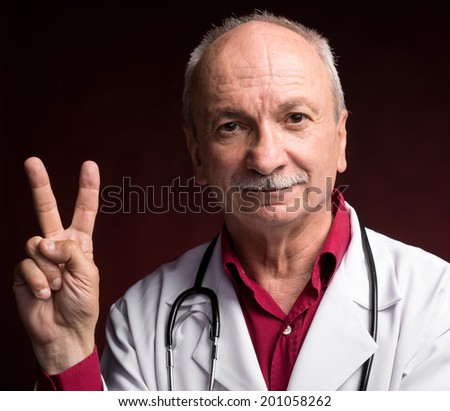 Medical doctor with stethoscope on a dark red background