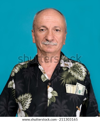 Lucky old man with dollar bills in the pocket on a blue background