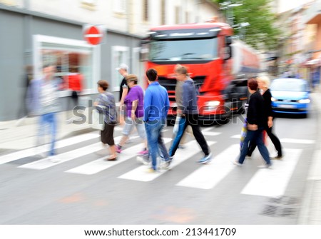 Busy city street people on zebra crossing. Intentional motion blur