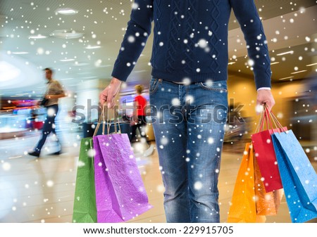 Man with shopping bags at shopping mall.  Christmas and holidays concept