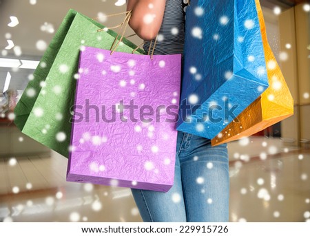 Woman with shopping bags at shopping mall.  Christmas and holidays concept