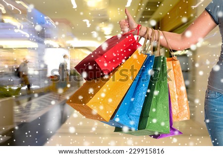 Female holding shopping bags at shopping mall.  Christmas and holidays concept