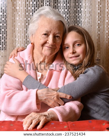 Portrait of grandmother and granddaughter at home