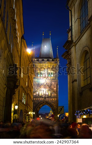 PRAGUE, CZECH REPUBLIC - 01 JANUARY 2015: Crowd of people on the way to the Charles Bridge in Prague, Czech Republic.Charles Bridge is a famous historical bridge that crosses the Vltava river.
