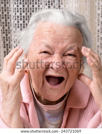 Closeup portrait of scared shouting old woman at home. Negative emotions