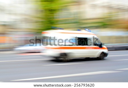 Ambulance in motion driving down the road. Intentional motion blur