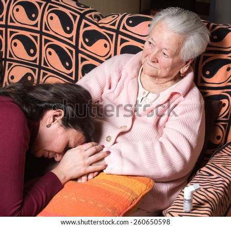 Sick old woman with granddaughter at home