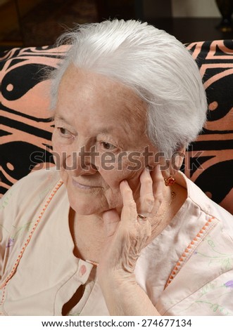 Portrait of smiling old woman at home