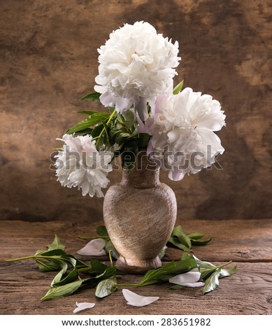 Beautiful bouquet of white peonies on a wooden background