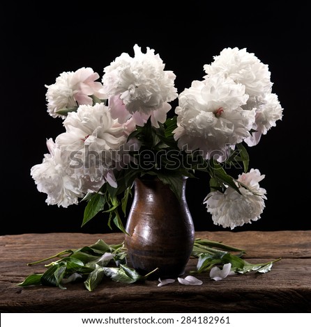 Beautiful bouquet of white peonies on a wooden background
