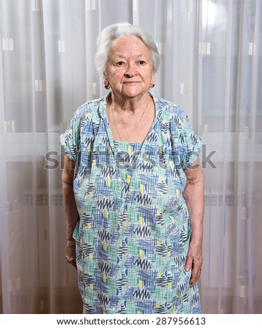 Portrait of  old smiling woman at home.