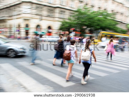 People crossing the street on the zebra crossing in motion blur