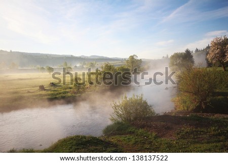 Foggy morning river mist rising up