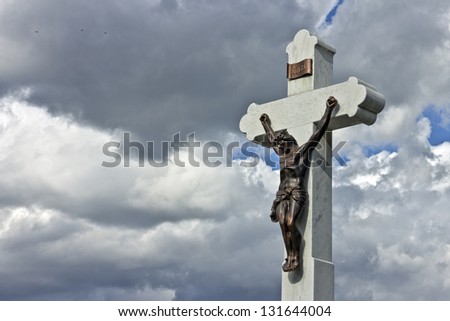 Jesus on the cross with clouds and blue sky in the background