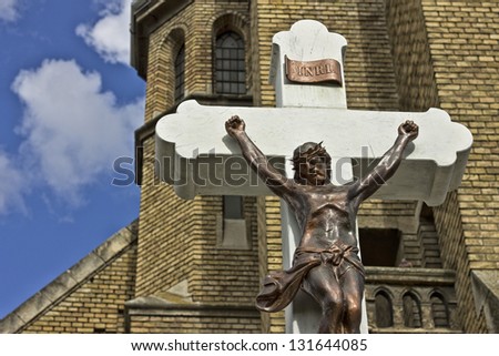 Jesus on the cross with clouds and blue sky in the background
