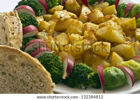 baked potatoes and vegetables, broccoli, Brussels sprouts ,radishes and homemade bread