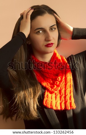 Beauty girl portrait, young fresh woman, face.  Shade from the sun falls on the face, a red scarf, black sweater, ready for winter.