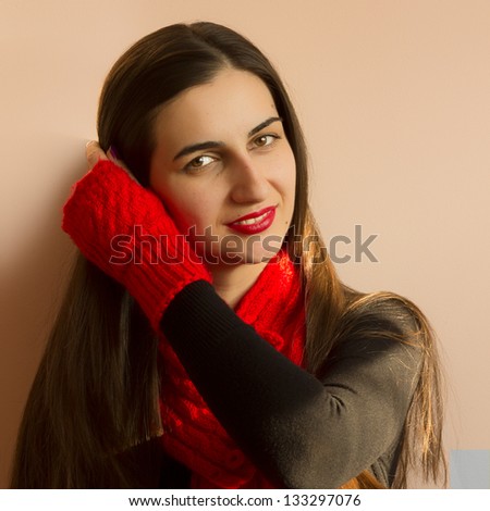 Beauty girl portrait, young fresh woman, face.  Shade from the sun falls on the face, a red scarf and gloves, ready for winter.