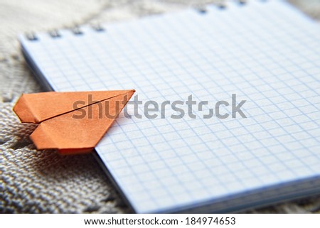 orange origami heart on a block note