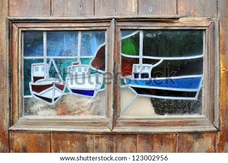Stained glass window depicting boats in Cadgwith, Cornwall, England