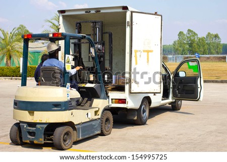 Worker drive forklift to pick-up product to the truck